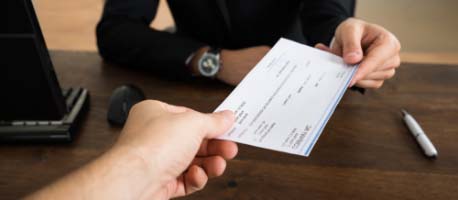 Person_giving_cheque_inside.jpg